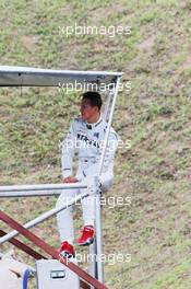 Michael Schumacher (GER) Mercedes AMG F1 watches practice from a cameraman's stand after he crashed out of the second practice session. 27.07.2012. Formula 1 World Championship, Rd 11, Hungarian Grand Prix, Budapest, Hungary, Practice Day