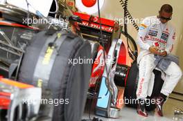 Lewis Hamilton (GBR) McLaren MP4/27 on his mobile phone in the pits. 27.07.2012. Formula 1 World Championship, Rd 11, Hungarian Grand Prix, Budapest, Hungary, Practice Day