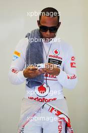 Lewis Hamilton (GBR) McLaren on his mobile phone in the pits. 27.07.2012. Formula 1 World Championship, Rd 11, Hungarian Grand Prix, Budapest, Hungary, Practice Day