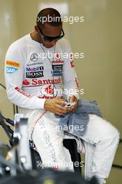 Lewis Hamilton (GBR) McLaren MP4/27 on his mobile phone in the pits. 27.07.2012. Formula 1 World Championship, Rd 11, Hungarian Grand Prix, Budapest, Hungary, Practice Day