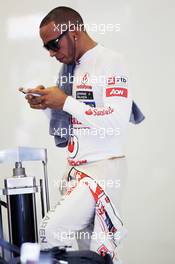 Lewis Hamilton (GBR) McLaren on his mobile phone in the pits. 27.07.2012. Formula 1 World Championship, Rd 11, Hungarian Grand Prix, Budapest, Hungary, Practice Day