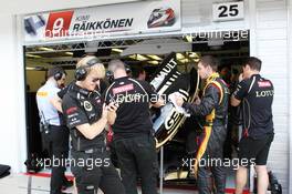 Andy Stobart (GBR) Lotus F1 Team Press Officer and the Lotus F1 Team form a human shield from Kimi Raikkonen (FIN) Lotus F1 E20 in the pits. 27.07.2012. Formula 1 World Championship, Rd 11, Hungarian Grand Prix, Budapest, Hungary, Practice Day