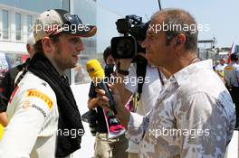 (L to R): Romain Grosjean (FRA) Lotus F1 Team wio Kai Ebel (GER) RTL TV Presenter on the grid. 29.07.2012. Formula 1 World Championship, Rd 11, Hungarian Grand Prix, Budapest, Hungary, Race Day