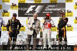The podium (L to R): Kimi Raikkonen (FIN) Lotus F1 Team, second; Placido Domingo (ESP); Lewis Hamilton (GBR) McLaren, race winner; Romain Grosjean (FRA) Lotus F1 Team, third. 29.07.2012. Formula 1 World Championship, Rd 11, Hungarian Grand Prix, Budapest, Hungary, Race Day