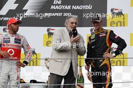 The podium (L to R): Race winner Lewis Hamilton (GBR) McLaren with Placido Domingo (ESP) and Romain Grosjean (FRA) Lotus F1 Team on the podium. 29.07.2012. Formula 1 World Championship, Rd 11, Hungarian Grand Prix, Budapest, Hungary, Race Day