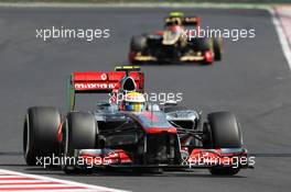 Lewis Hamilton (GBR) McLaren MP4/27 leads Romain Grosjean (FRA) Lotus F1 E20. 29.07.2012. Formula 1 World Championship, Rd 11, Hungarian Grand Prix, Budapest, Hungary, Race Day