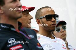 (L to R): Christian Horner (GBR) Red Bull Racing Team Principal; Niki Lauda (AUT); Lewis Hamilton (GBR) McLaren and Sergio Perez (MEX) Sauber pay their respects to the Hungarian GP Promoter Tamas Frank, who died last month. 28.07.2012. Formula 1 World Championship, Rd 11, Hungarian Grand Prix, Budapest, Hungary, Qualifying Day