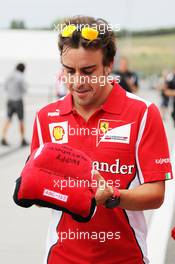 Fernando Alonso (ESP) Ferrari with an early birthday present. 26.07.2012. Formula 1 World Championship, Rd 11, Hungarian Grand Prix, Budapest, Hungary, Preparation Day