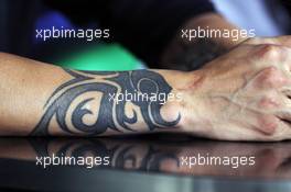 A tattoo on the arm of Kimi Raikkonen (FIN) Lotus F1 Team in the FIA Press Conference. 26.07.2012. Formula 1 World Championship, Rd 11, Hungarian Grand Prix, Budapest, Hungary, Preparation Day