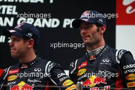 (L to R): Race winner Sebastian Vettel (GER) Red Bull Racing and Mark Webber (AUS) Red Bull Racing on the podium. 28.10.2012. Formula 1 World Championship, Rd 17, Indian Grand Prix, New Delhi, India, Race Day.
