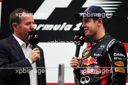 (L to R): Martin Brundle (GBR) Sky Sports Commentator with race winner Sebastian Vettel (GER) Red Bull Racing on the podium. 28.10.2012. Formula 1 World Championship, Rd 17, Indian Grand Prix, New Delhi, India, Race Day.