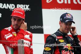 (L to R): Fernando Alonso (ESP) Ferrari with race winner Sebastian Vettel (GER) Red Bull Racing on the podium. 28.10.2012. Formula 1 World Championship, Rd 17, Indian Grand Prix, New Delhi, India, Race Day.