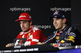 Fernando Alonso (ESP) Ferrari and Sebastian Vettel (GER) Red Bull Racing in the FIA Press Conference. 28.10.2012. Formula 1 World Championship, Rd 17, Indian Grand Prix, New Delhi, India, Race Day.