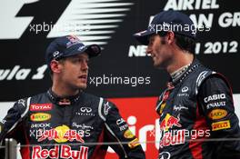 (L to R): Race winner Sebastian Vettel (GER) Red Bull Racing with Mark Webber (AUS) Red Bull Racing on the podium. 28.10.2012. Formula 1 World Championship, Rd 17, Indian Grand Prix, New Delhi, India, Race Day.