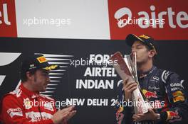 Race winner Sebastian Vettel (GER) Red Bull Racing on the podium with Fernando Alonso (ESP) Ferrari. 28.10.2012. Formula 1 World Championship, Rd 17, Indian Grand Prix, New Delhi, India, Race Day.