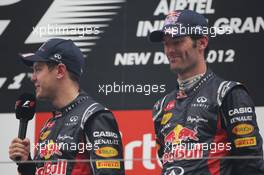 (L to R): Race winner Sebastian Vettel (GER) Red Bull Racing and Mark Webber (AUS) Red Bull Racing on the podium. 28.10.2012. Formula 1 World Championship, Rd 17, Indian Grand Prix, New Delhi, India, Race Day.