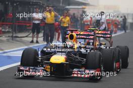 Race winner Sebastian Vettel (GER) Red Bull Racing RB8 celebrates as he enters parc ferme, being pushed along by team mate Mark Webber (AUS) Red Bull Racing RB8. 28.10.2012. Formula 1 World Championship, Rd 17, Indian Grand Prix, New Delhi, India, Race Day.