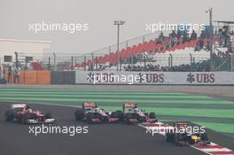 Lewis Hamilton (GBR) McLaren MP4/27, Jenson Button (GBR) McLaren MP4/27 and Fernando Alonso (ESP) Ferrari F2012 battle for position behind Mark Webber (AUS) Red Bull Racing RB8. 28.10.2012. Formula 1 World Championship, Rd 17, Indian Grand Prix, New Delhi, India, Race Day.