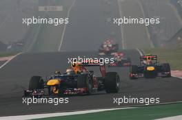 Sebastian Vettel (GER) Red Bull Racing RB8 leads team mate Mark Webber (AUS) Red Bull Racing RB8. 28.10.2012. Formula 1 World Championship, Rd 17, Indian Grand Prix, New Delhi, India, Race Day.