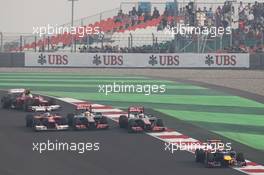 Lewis Hamilton (GBR) McLaren MP4/27, Jenson Button (GBR) McLaren MP4/27 and Fernando Alonso (ESP) Ferrari F2012 battle for position behind Mark Webber (AUS) Red Bull Racing RB8. 28.10.2012. Formula 1 World Championship, Rd 17, Indian Grand Prix, New Delhi, India, Race Day.