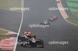 Romain Grosjean (FRA) Lotus F1 E20 leads Jenson Button (GBR) McLaren MP4/27. 28.10.2012. Formula 1 World Championship, Rd 17, Indian Grand Prix, New Delhi, India, Race Day.