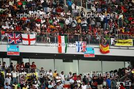 Fans in the grandstand. 28.10.2012. Formula 1 World Championship, Rd 17, Indian Grand Prix, New Delhi, India, Race Day.