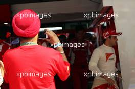 Ferrari fan photographs Felipe Massa (BRA) Ferrari in the pits.