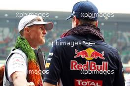 (L to R): Michael Schumacher (GER) Mercedes AMG F1 with Sebastian Vettel (GER) Red Bull Racing on the drivers parade. 28.10.2012. Formula 1 World Championship, Rd 17, Indian Grand Prix, New Delhi, India, Race Day.