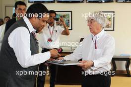 Bernie Ecclestone (GBR) CEO Formula One Group (FOM) is presented with gifts by Manoj Gaur (IND) Executive Chairman and CEO Jaypee Group and Sameer Gaur (IND), MD & CEO Jaypee Sports International Ltd on his 82nd birthday. 28.10.2012. Formula 1 World Championship, Rd 17, Indian Grand Prix, New Delhi, India, Race Day.