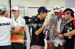 (L to R): Sebastian Vettel (GER) Red Bull Racing, Michael Schumacher (GER) Mercedes AMG F1 and Timo Glock (GER) Marussia F1 Team enjoy something on a mobile phone. 28.10.2012. Formula 1 World Championship, Rd 17, Indian Grand Prix, New Delhi, India, Race Day.