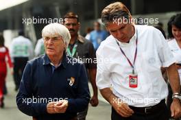 (L to R): Bernie Ecclestone (GBR) CEO Formula One Group (FOM) with Pasquale Lattuneddu (ITA) of the FOM. 25.10.2012. Formula 1 World Championship, Rd 17, Indian Grand Prix, New Delhi, India, Preparation Day