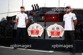(L to R): Jenson Button (GBR) McLaren and Lewis Hamilton (GBR) McLaren sign their race overalls. 07.09.2012. Formula 1 World Championship, Rd 13, Italian Grand Prix, Monza, Italy, Practice Day