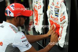 Lewis Hamilton (GBR) McLaren signs his race overalls. 07.09.2012. Formula 1 World Championship, Rd 13, Italian Grand Prix, Monza, Italy, Practice Day