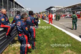 Red Bull Racing mechanics await their cars on the grid. 09.09.2012. Formula 1 World Championship, Rd 13, Italian Grand Prix, Monza, Italy, Race Day