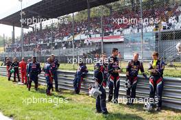 Red Bull Racing mechanics await their cars on the grid. 09.09.2012. Formula 1 World Championship, Rd 13, Italian Grand Prix, Monza, Italy, Race Day