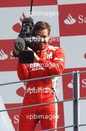 Third placed Fernando Alonso (ESP) Ferrari takes control of a FOM Camera on the podium. 09.09.2012. Formula 1 World Championship, Rd 13, Italian Grand Prix, Monza, Italy, Race Day