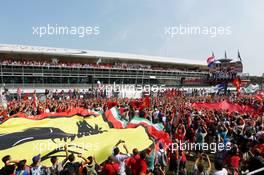 The podium (L to R): Sergio Perez (MEX) Sauber, second; Lewis Hamilton (GBR) McLaren, race winner; Fernando Alonso (ESP) Ferrari, third as giant Ferrari flag covers the fans on the race track. 09.09.2012. Formula 1 World Championship, Rd 13, Italian Grand Prix, Monza, Italy, Race Day
