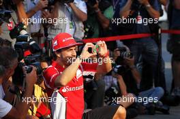 Fernando Alonso (ESP) Ferrari F2012 takes a picture of the Ferrari 512 with his smart phone. 08.09.2012. Formula 1 World Championship, Rd 13, Italian Grand Prix, Monza, Italy, Qualifying Day