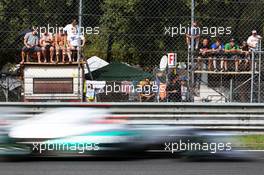 Michael Schumacher (GER) Mercedes AMG F1 W03 passes fans on makeshift grandstands. 08.09.2012. Formula 1 World Championship, Rd 13, Italian Grand Prix, Monza, Italy, Qualifying Day