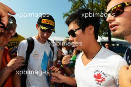 Kamui Kobayashi (JPN) Sauber signs autographs for the fans. 06.09.2012. Formula 1 World Championship, Rd 13, Italian Grand Prix, Monza, Italy, Preparation Day