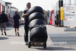 Scuderia Toro Rosso mechanic with Pirelli tyres. 06.09.2012. Formula 1 World Championship, Rd 13, Italian Grand Prix, Monza, Italy, Preparation Day