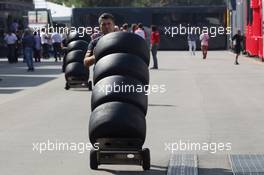 Scuderia Toro Rosso mechanic with Pirelli tyres. 06.09.2012. Formula 1 World Championship, Rd 13, Italian Grand Prix, Monza, Italy, Preparation Day