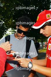 Daniel Ricciardo (AUS) Scuderia Toro Rosso signs autographs for the fans. 06.09.2012. Formula 1 World Championship, Rd 13, Italian Grand Prix, Monza, Italy, Preparation Day