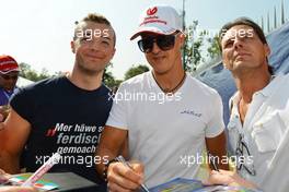 Michael Schumacher (GER) Mercedes AMG F1 signs autographs for the fans. 06.09.2012. Formula 1 World Championship, Rd 13, Italian Grand Prix, Monza, Italy, Preparation Day