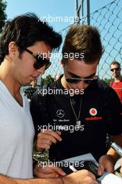 Sergio Perez (MEX) Sauber signs autographs for the fans. 06.09.2012. Formula 1 World Championship, Rd 13, Italian Grand Prix, Monza, Italy, Preparation Day