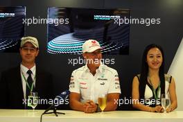 Michael Schumacher (GER) Mercedes AMG F1 at the tie-in with an GPS navigation company Erlinyou with the CEO (Left) and the President (Right). 06.09.2012. Formula 1 World Championship, Rd 13, Italian Grand Prix, Monza, Italy, Preparation Day
