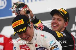 Kamui Kobayashi (JPN) Sauber celebrates his third position on the podium with race winner Sebastian Vettel (GER) Red Bull Racing. 07.10.2012. Formula 1 World Championship, Rd 15, Japanese Grand Prix, Suzuka, Japan, Race Day.