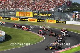 Sebastian Vettel (GER) Red Bull Racing RB8 leads at the start of the race as Fernando Alonso (ESP) Ferrari F2012 crashes out after contact with Kimi Raikkonen (FIN) Lotus F1 E20. 07.10.2012. Formula 1 World Championship, Rd 15, Japanese Grand Prix, Suzuka, Japan, Race Day.