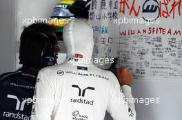 Bruno Senna (BRA) Williams takes a look at messages of suppport on a banner in the pit garage.