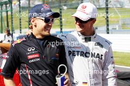 (L to R): Sebastian Vettel (GER) Red Bull Racing with Michael Schumacher (GER) Mercedes AMG F1 on the drivers parade. 07.10.2012. Formula 1 World Championship, Rd 15, Japanese Grand Prix, Suzuka, Japan, Race Day.
